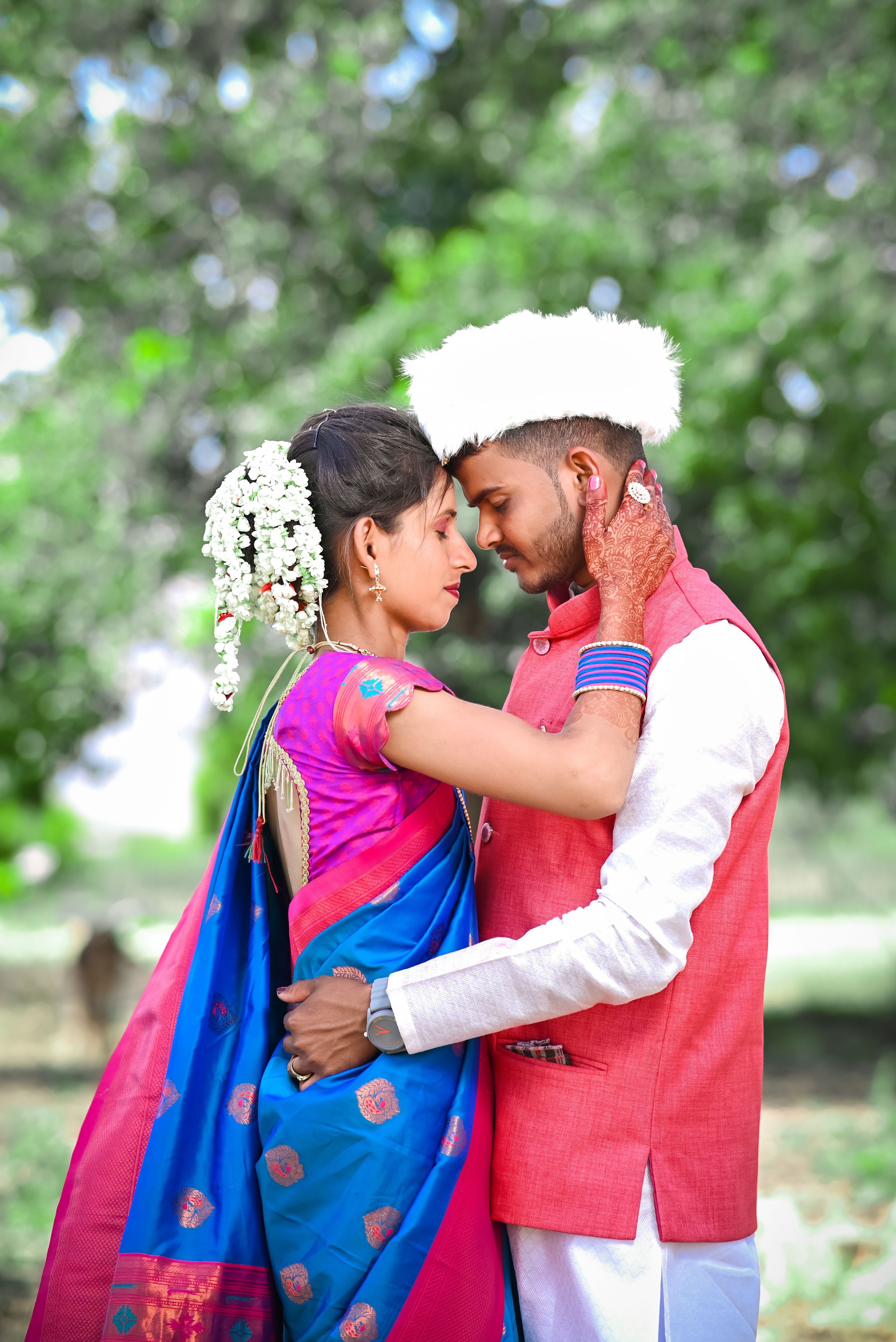 A couple in traditional attire hugging each other · Free Stock Photo