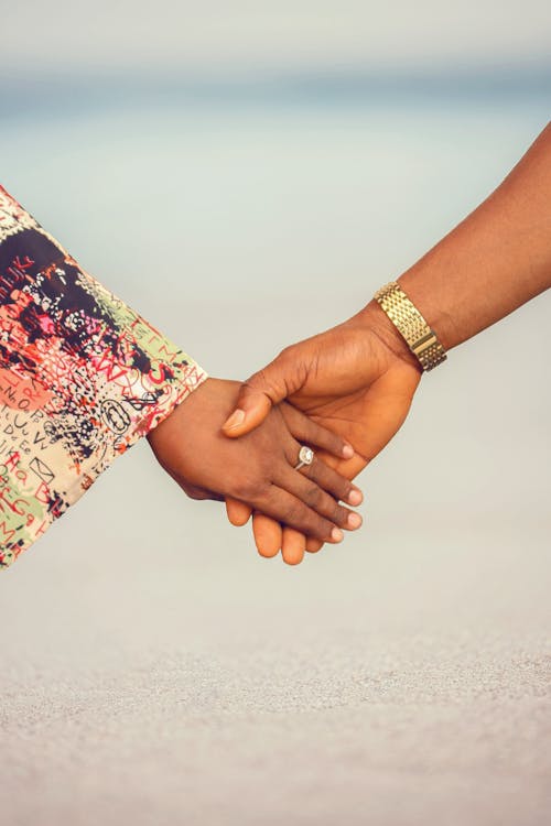 A couple holding hands on the beach