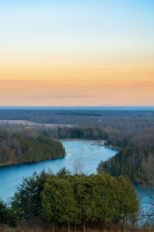 Free A stunning aerial view of the Green Lakes State Park in Fayetteville, NY during sunset, showcasing the surrounding forest and serene lake. Stock Photo
