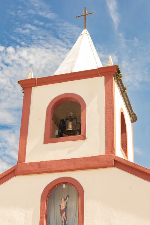 A church with a bell tower and a cross on top