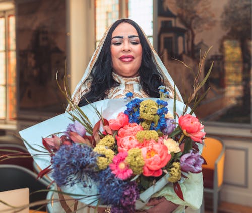 A woman in a wedding dress holding a bouquet