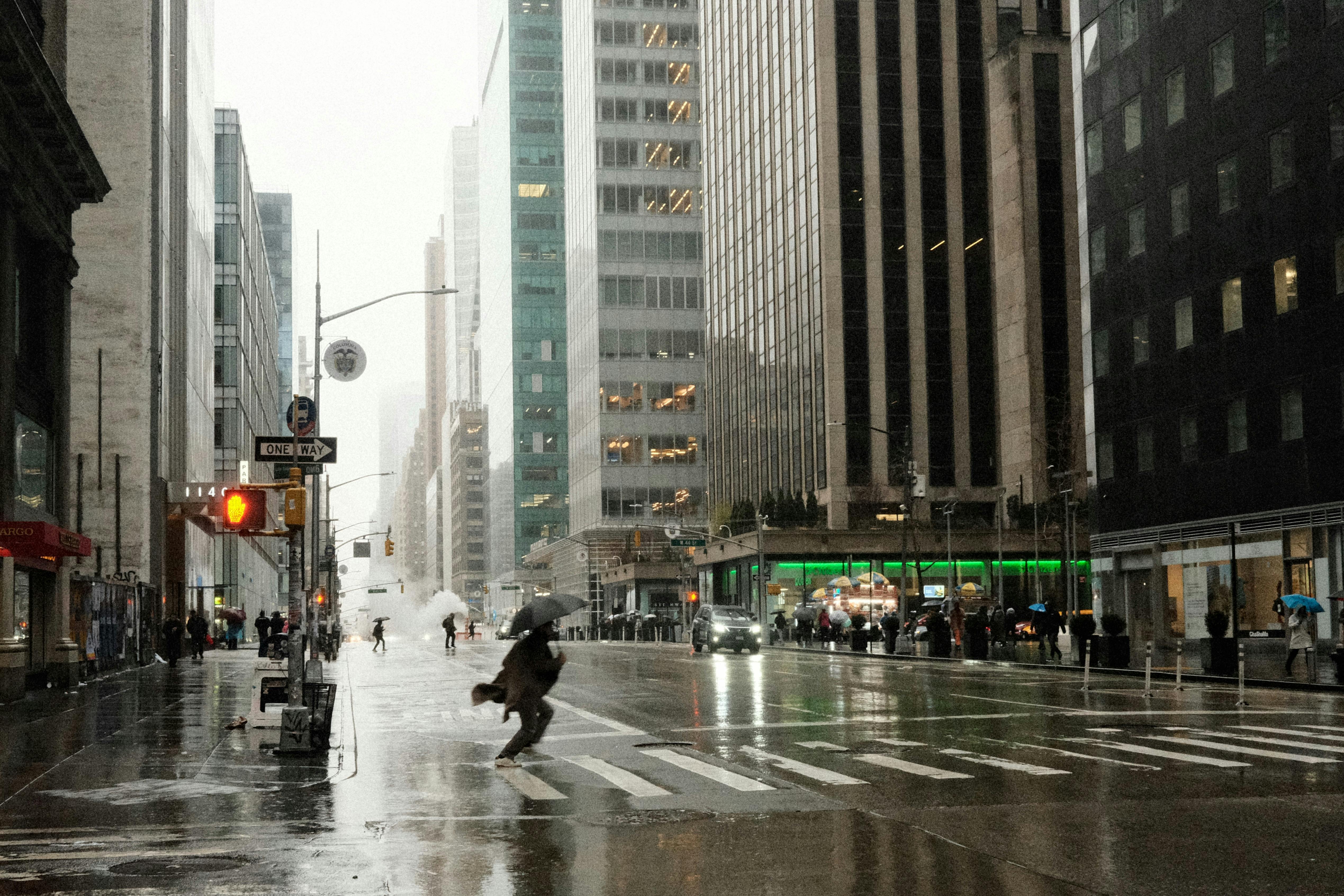 person crossing street in new york in rain