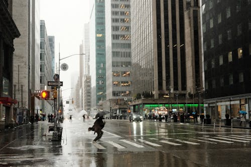Person Crossing Street in New York in Rain