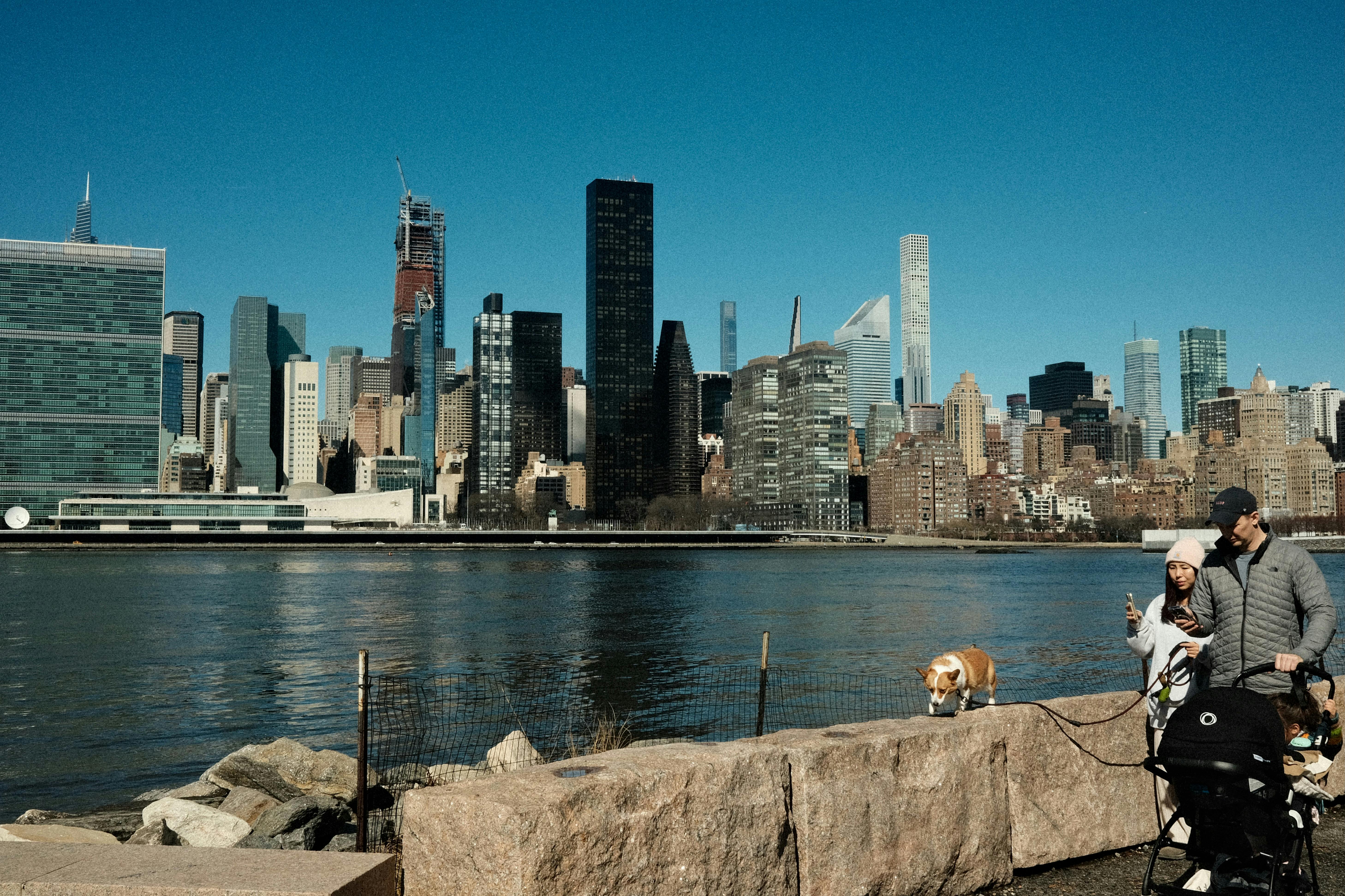 Couple Walking with Stroller and Dog on New York Coast