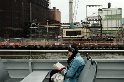 A woman reading a book on a boat