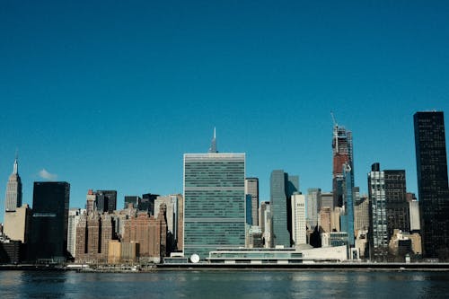 The united nations building is seen from the water