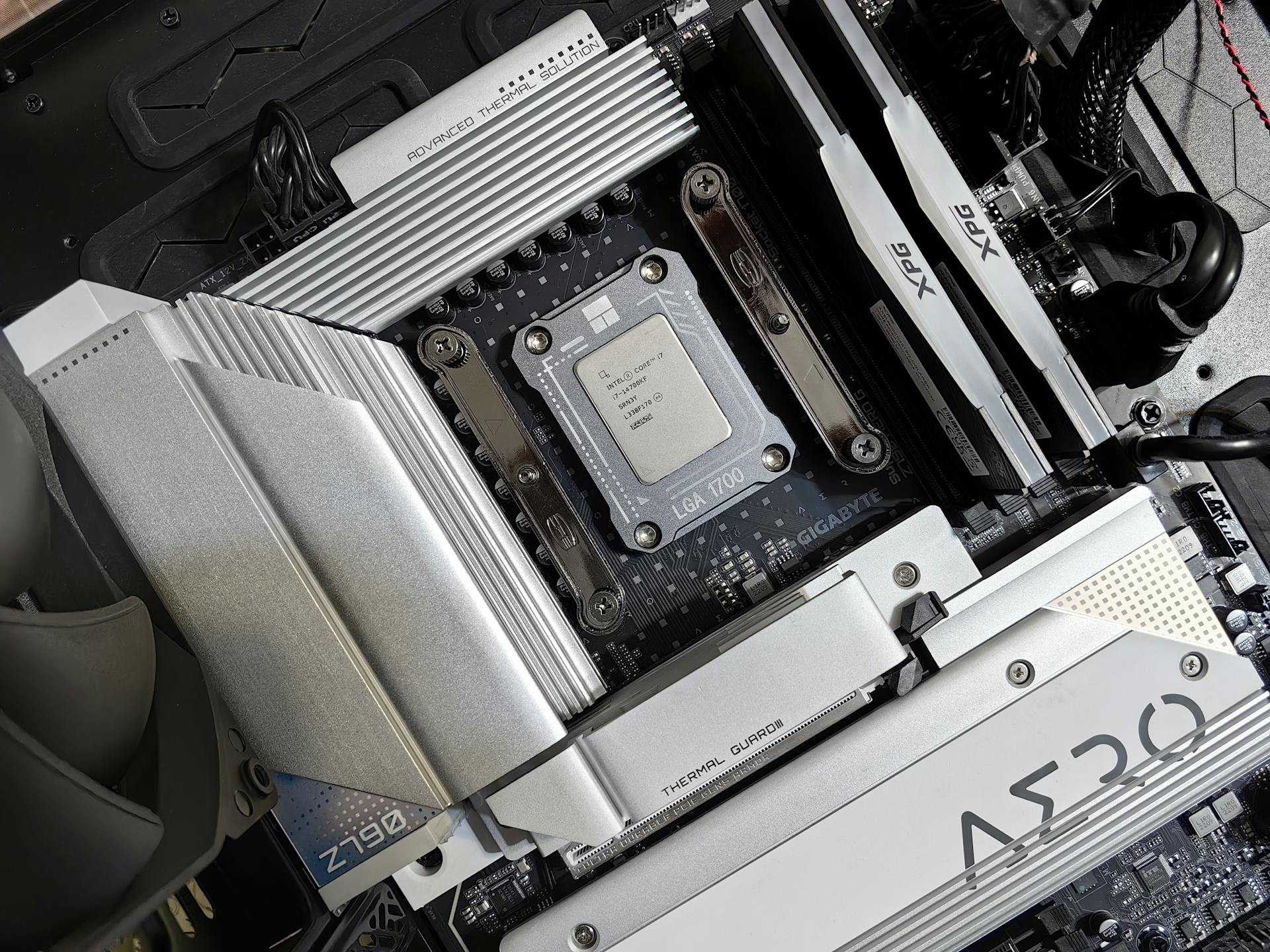 Detailed view of a computer motherboard with installed processor and heat sink.