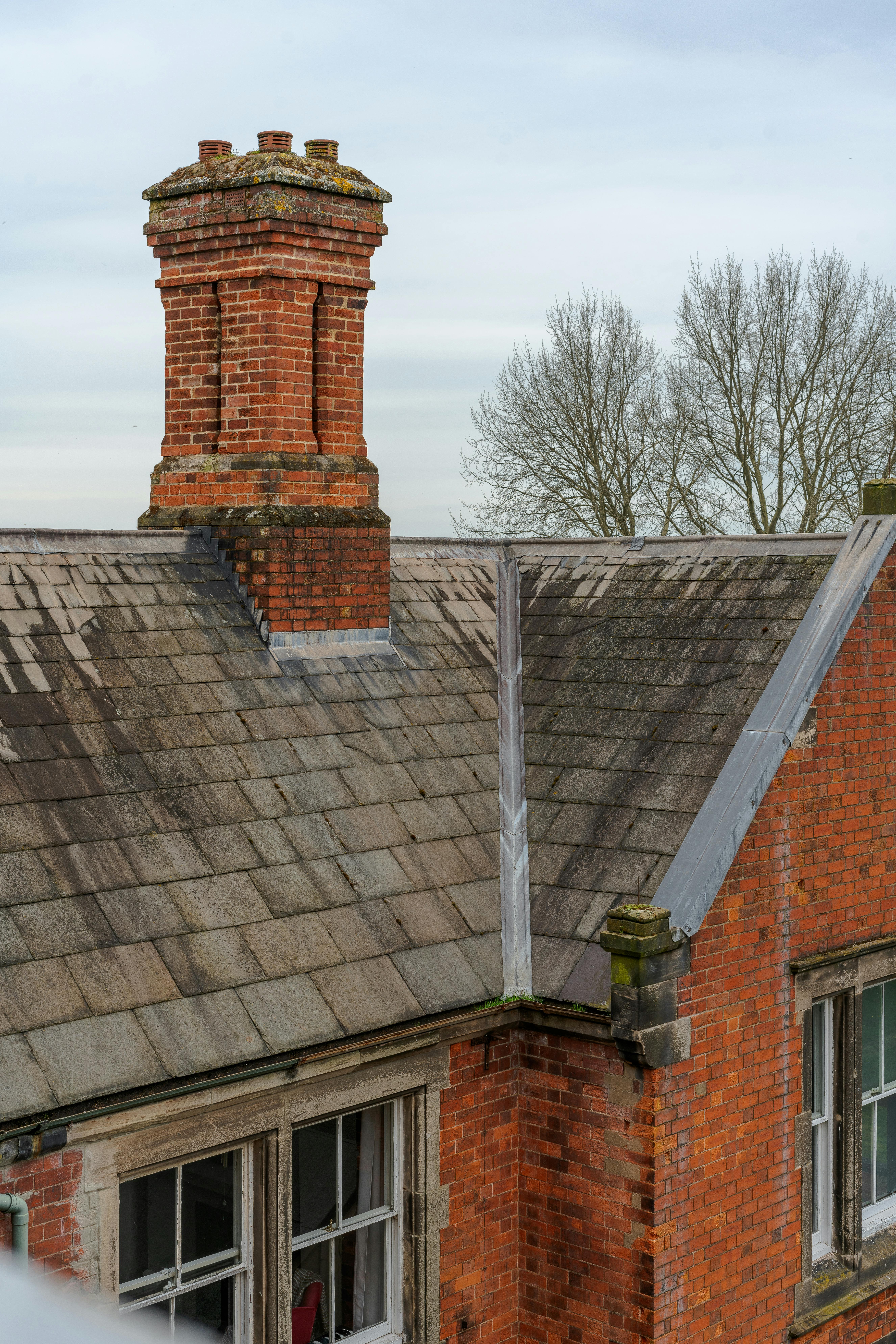A classic brick house rooftop with chimney, capturing vintage architecture in Derby, UK.