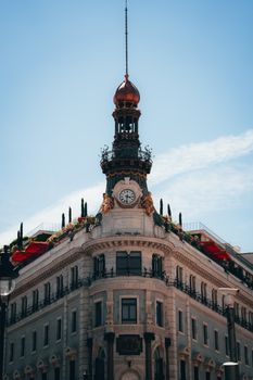 Elegant clock tower with ornate architectural details in Madrid.