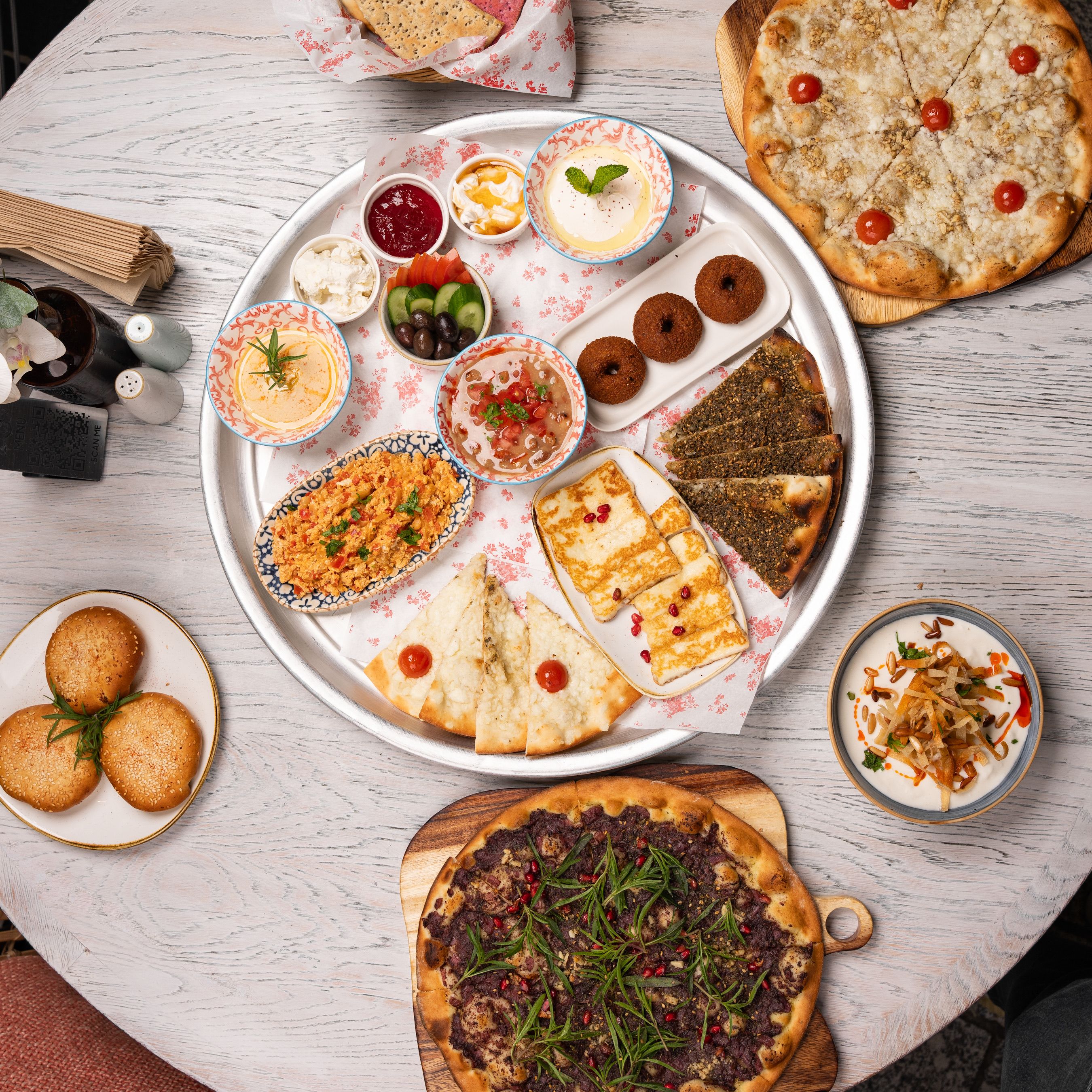Vibrant Middle Eastern mezze platter showcasing a variety of delicious appetizers and flatbreads.