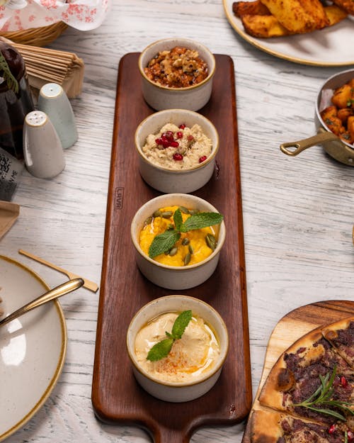 A wooden tray with four different types of food