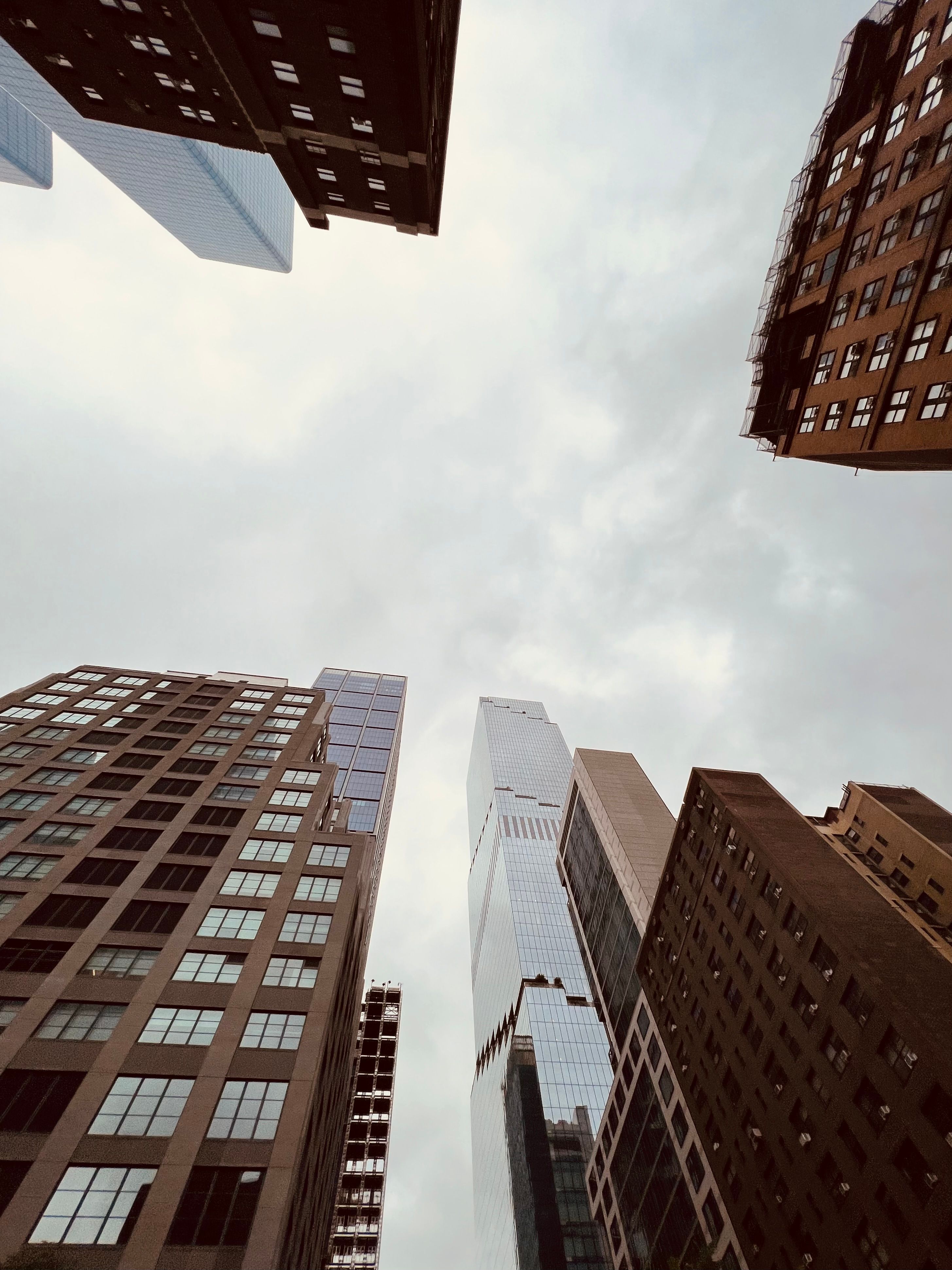 Low Angle Shot of Modern Skyscrapers under a Cloudy Sky · Free Stock Photo