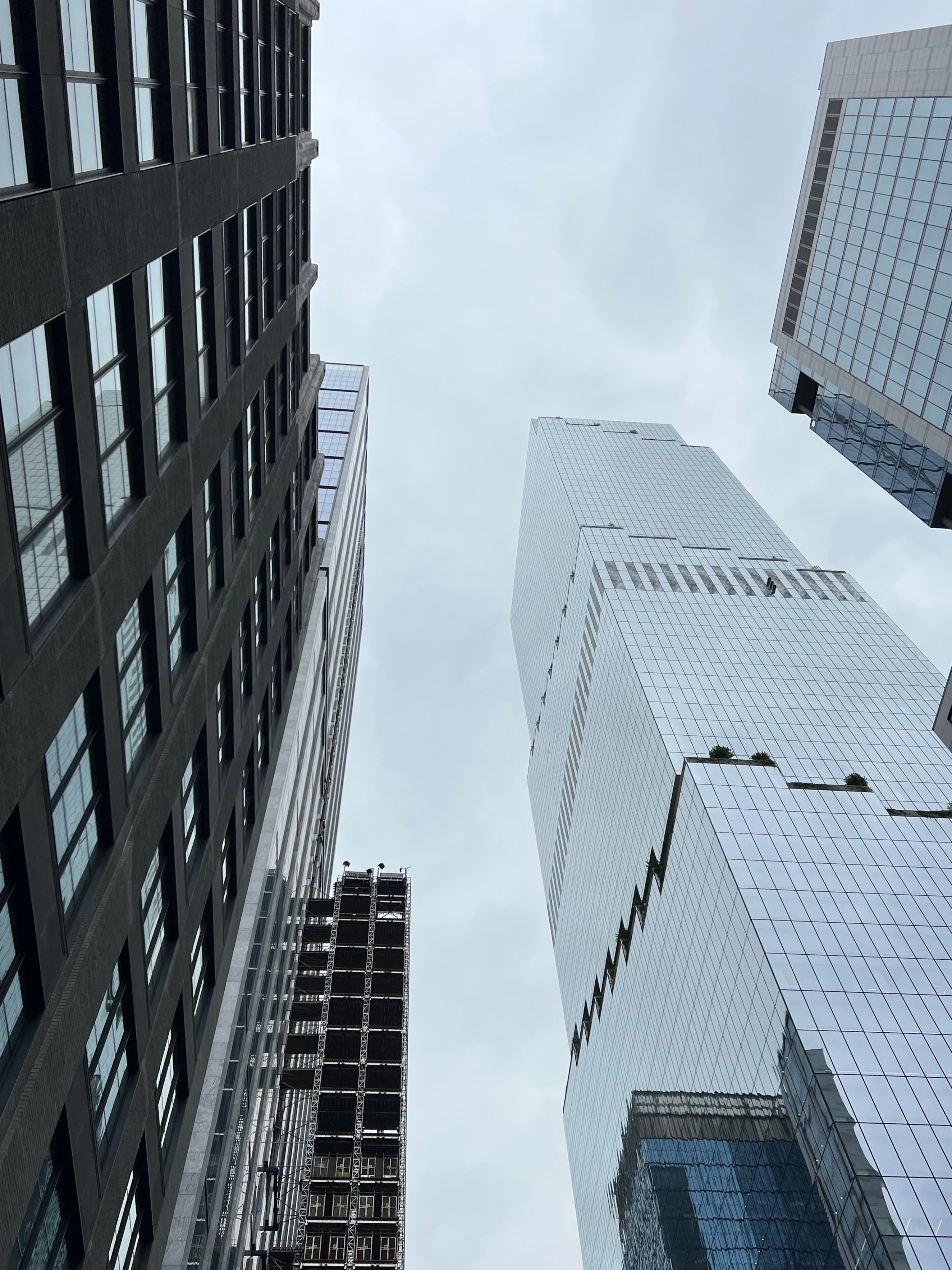 Low Angle Shot of Modern Skyscrapers under a Cloudy Sky · Free Stock Photo