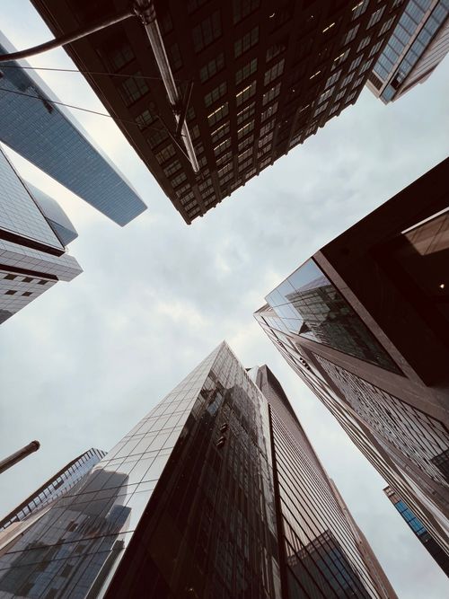 Free Low-angle view of modern skyscrapers against an overcast sky in a financial district. Stock Photo