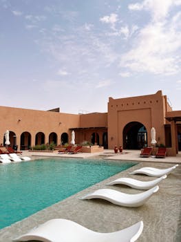 Elegant resort featuring a swimming pool and sun loungers in Abu Dhabi.