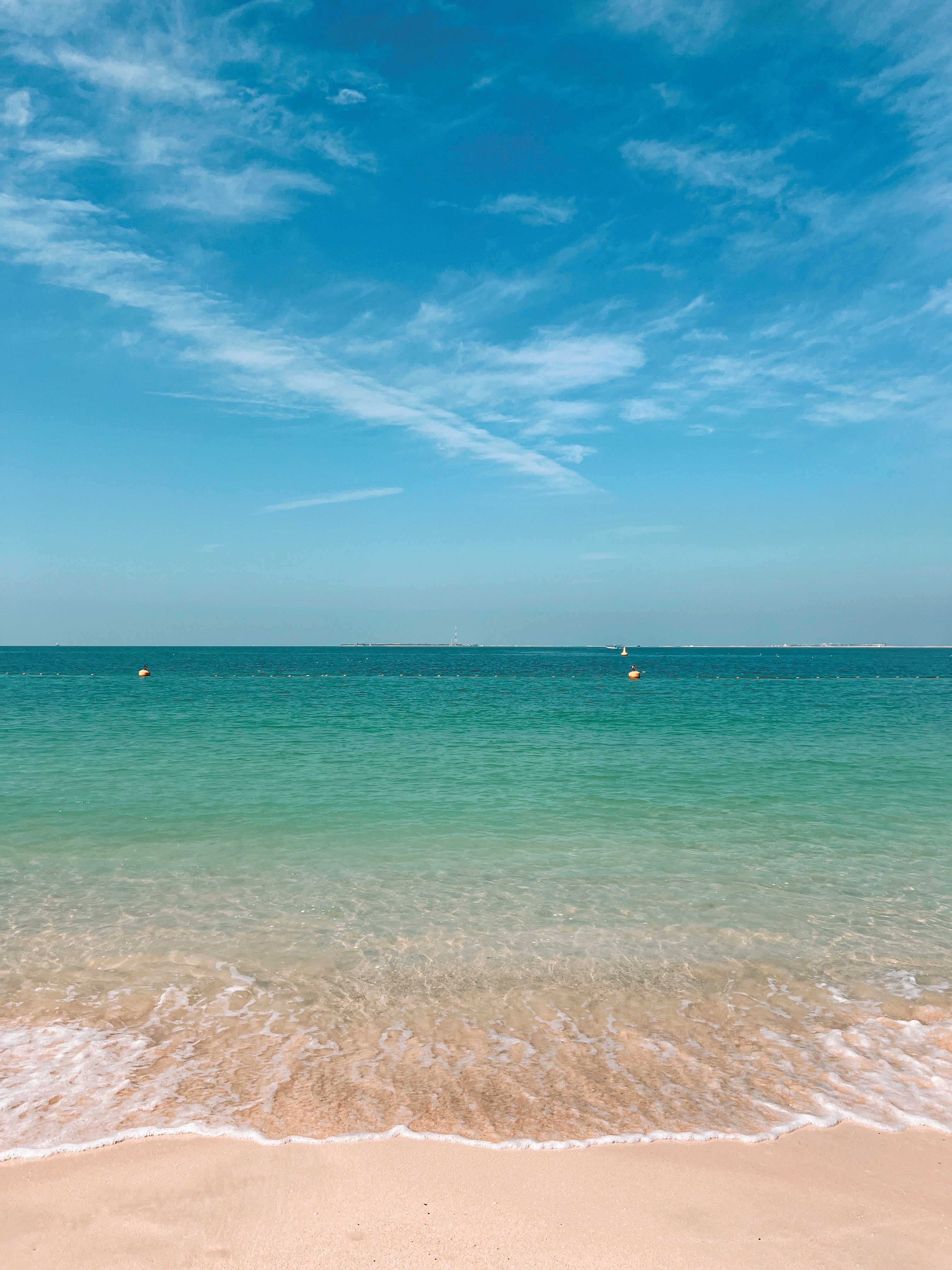 View of a Beach and Turquoise Sea Water under Blue Sky · Free Stock Photo