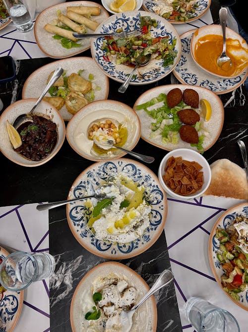A table full of plates of food with different types of food