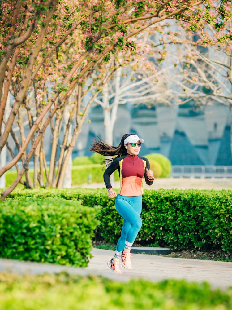 Woman In Sportswear Running At Park