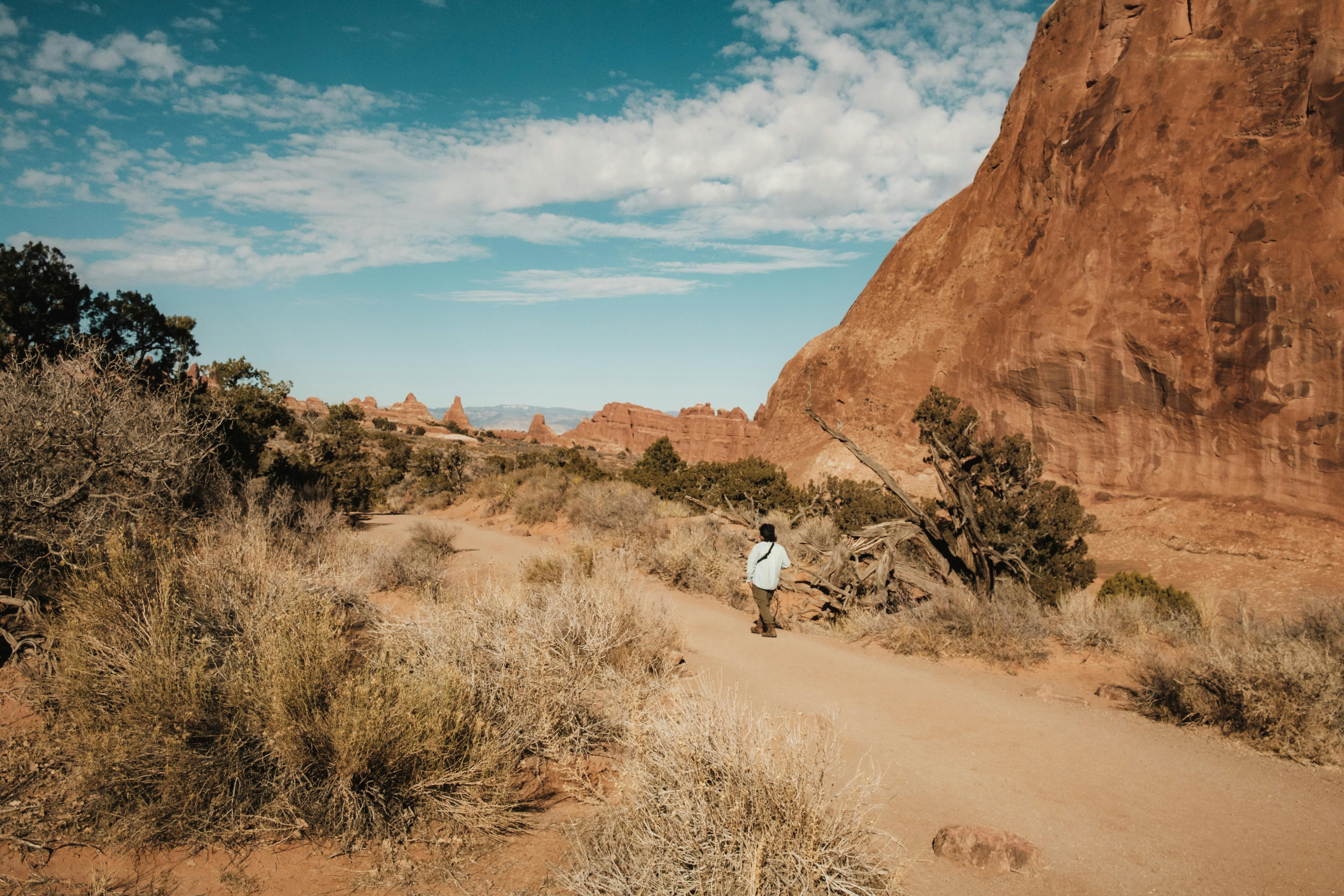 person walking on footpath in arches national park