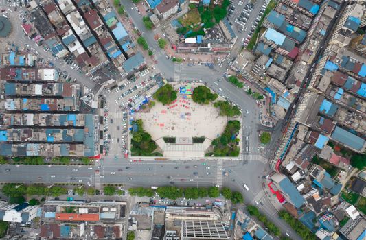 Aerial view of a bustling city square in Jiujiang, China showcasing urban life and architecture.