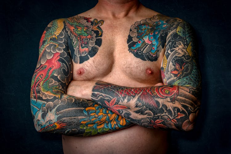 Man Showing His Arm Tattoos