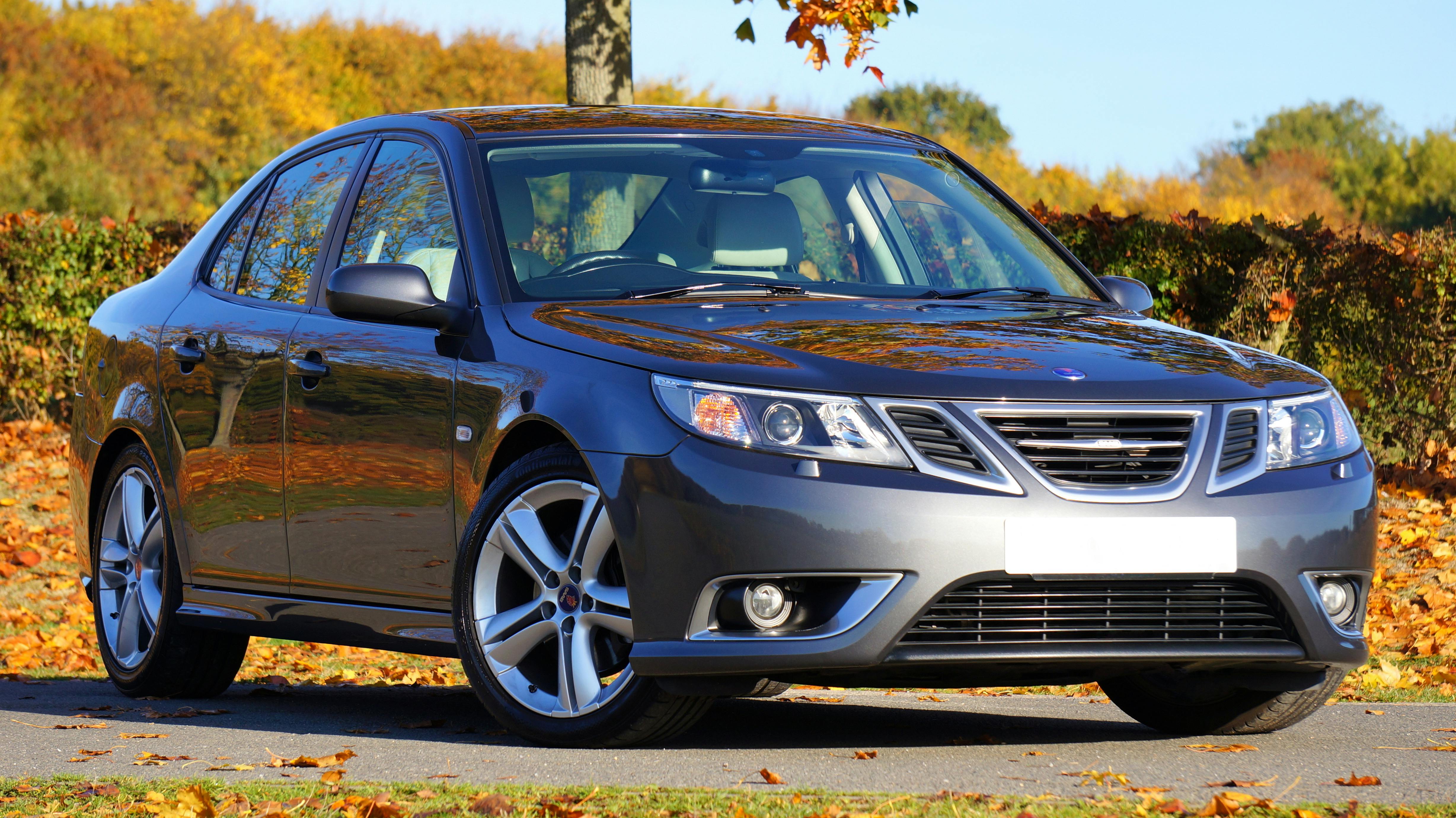 silver sedan near green plants during daytime free stock photo pexels