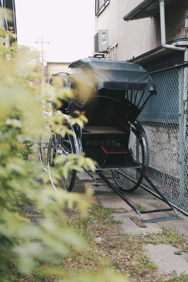 Black Rickshaw On Narrow Pathway