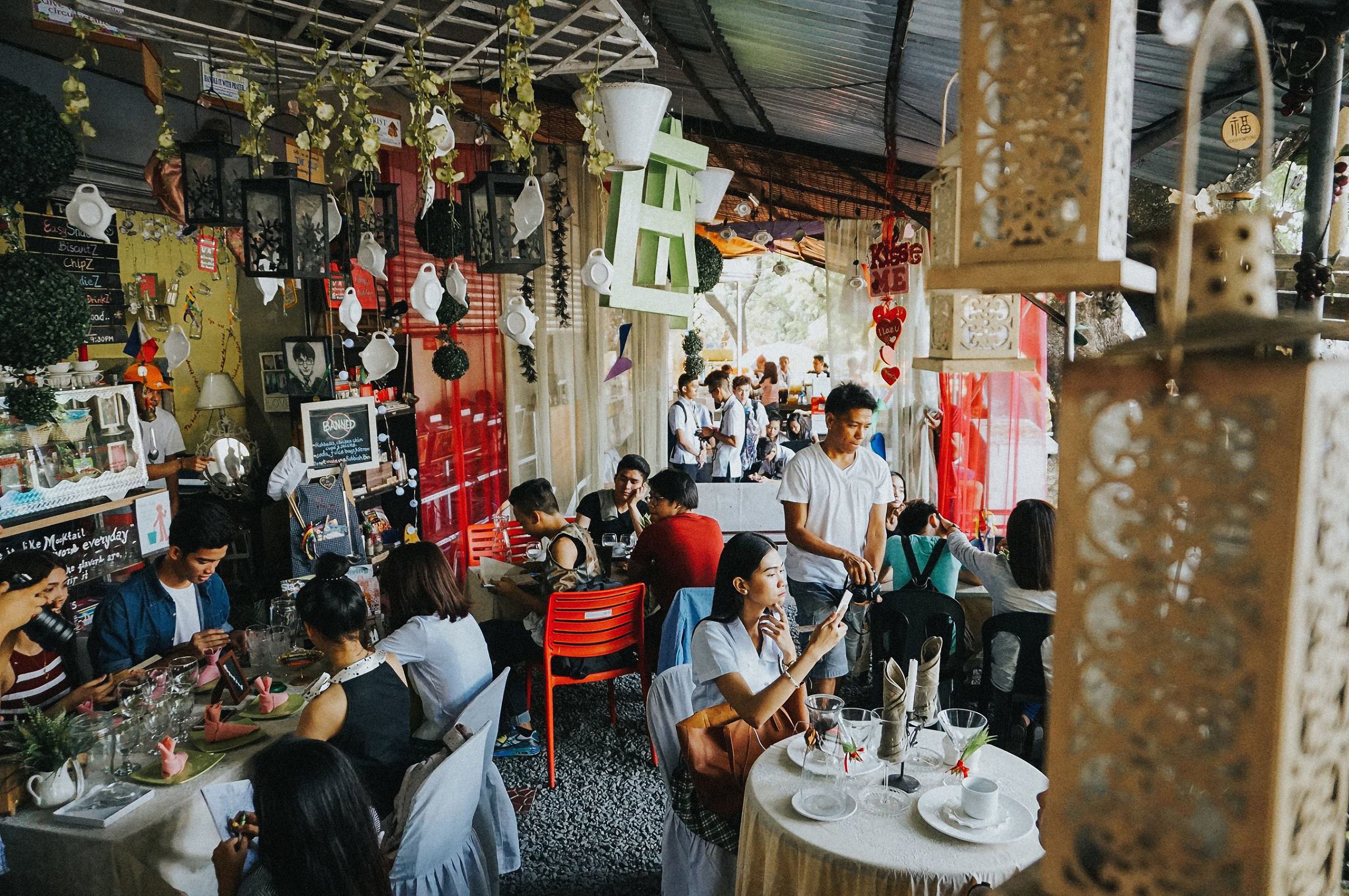 The vibrant and colorful interior of Cafe Jumping Bean, showcasing eclectic decor, art on the walls, and a cozy, inviting atmosphere with patrons enjoying coffee and conversations. - mexican restaurants pilsen neighborhood