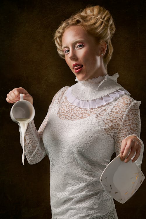 Free Woman Wearing White Floral Long Sleeve Dress Holding Cup And Saucer Stock Photo