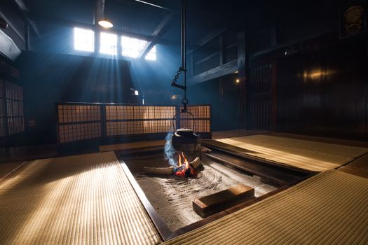 A serene Japanese tatami room with sunlight streaming in and a traditional fire pit.