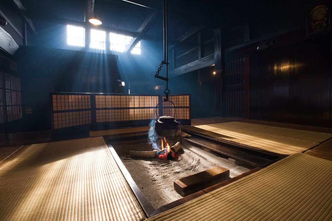 Traditional Japanese tatami room with wooden beams and sunlight