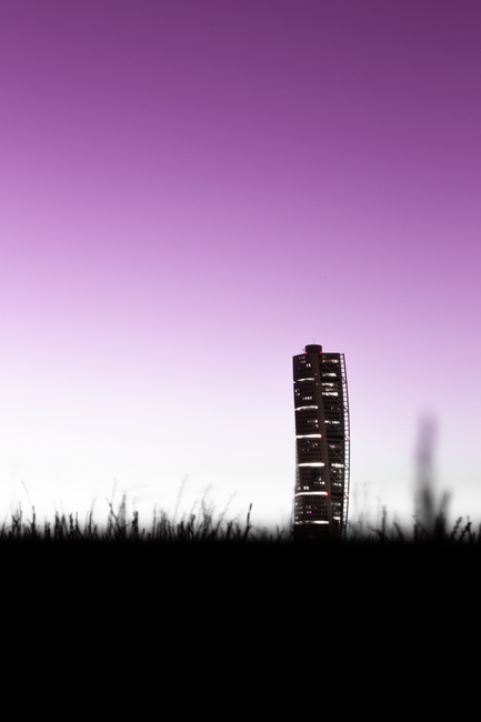 Minimalist silhouette of a modern skyscraper against a purple sky at dusk in Sweden.
