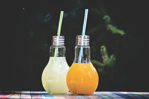 Two lamp- shaped jars with fruit smoothies