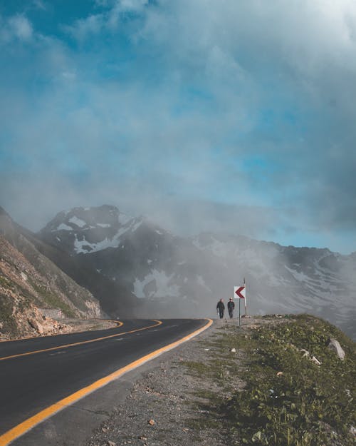 Free Two Person Walking Beside Road Stock Photo
