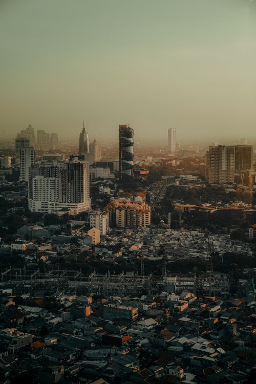 Free Aerial view of Jakarta's skyline with modern skyscrapers at sunset. Stock Photo