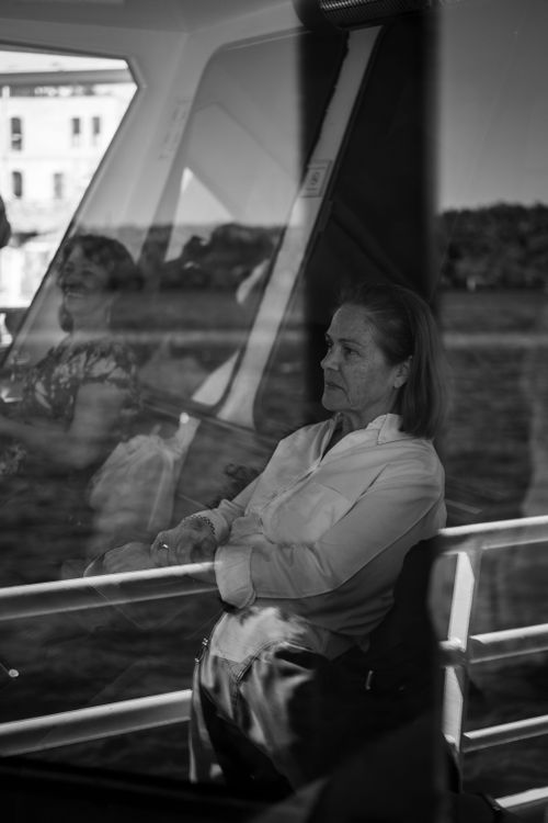 Free Black and white photo of a woman reflected in a ferry window. Stock Photo