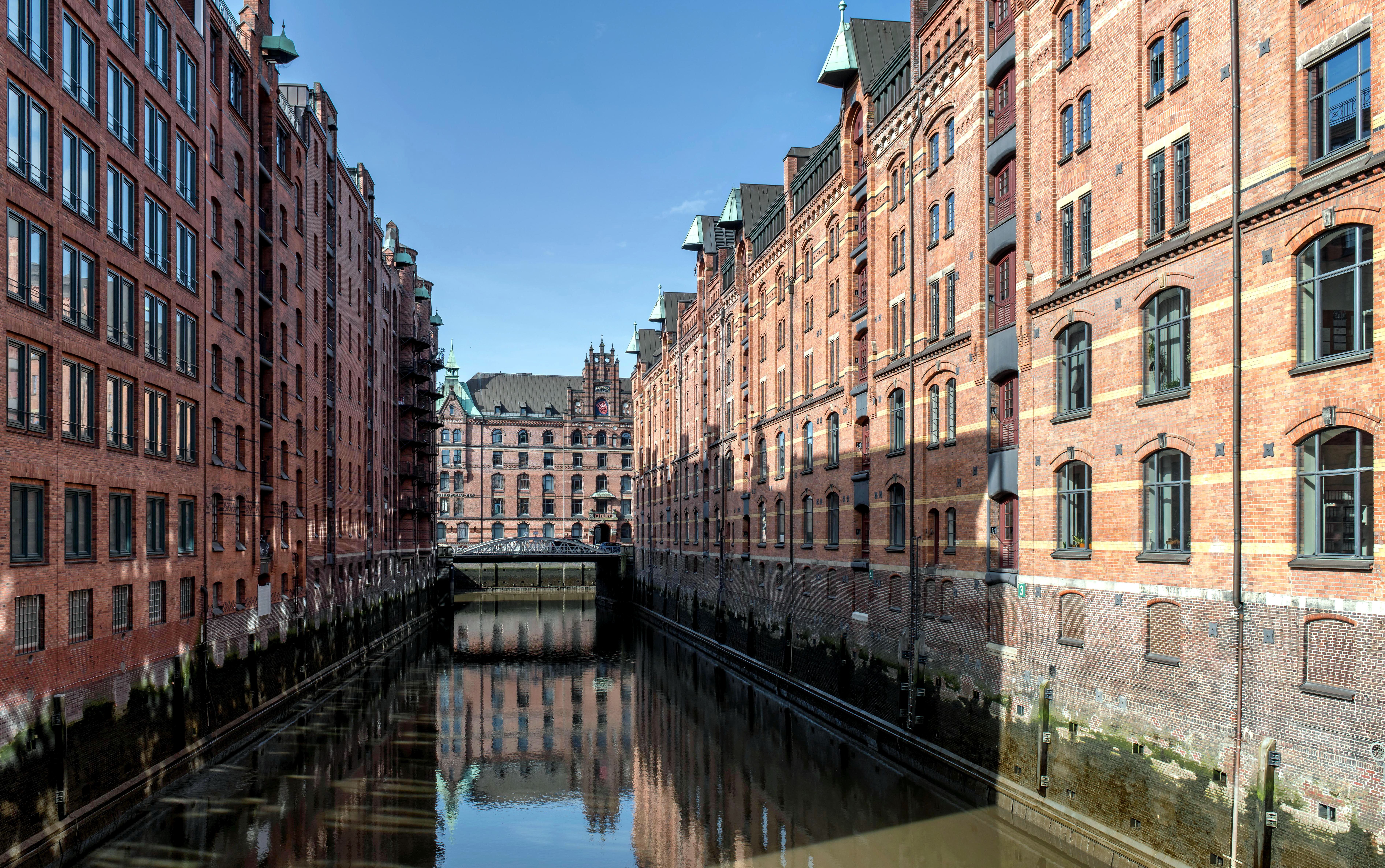 View of Hamburg's iconic Speicherstadt district with canal reflection.
