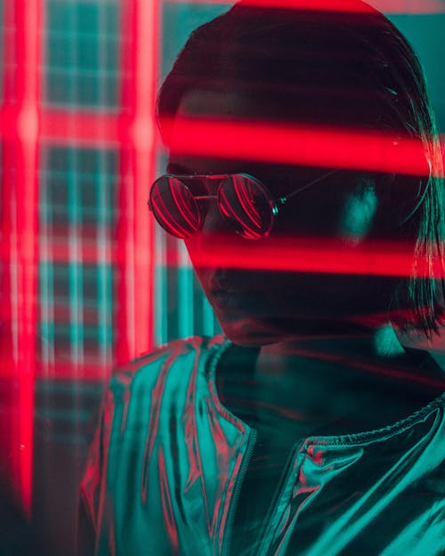 Free Woman Wearing Sunglasses Near Red Lights Stock Photo