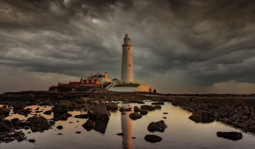 Free A stunning view of St Mary's Lighthouse with a dramatic cloudy sky at twilight. Stock Photo