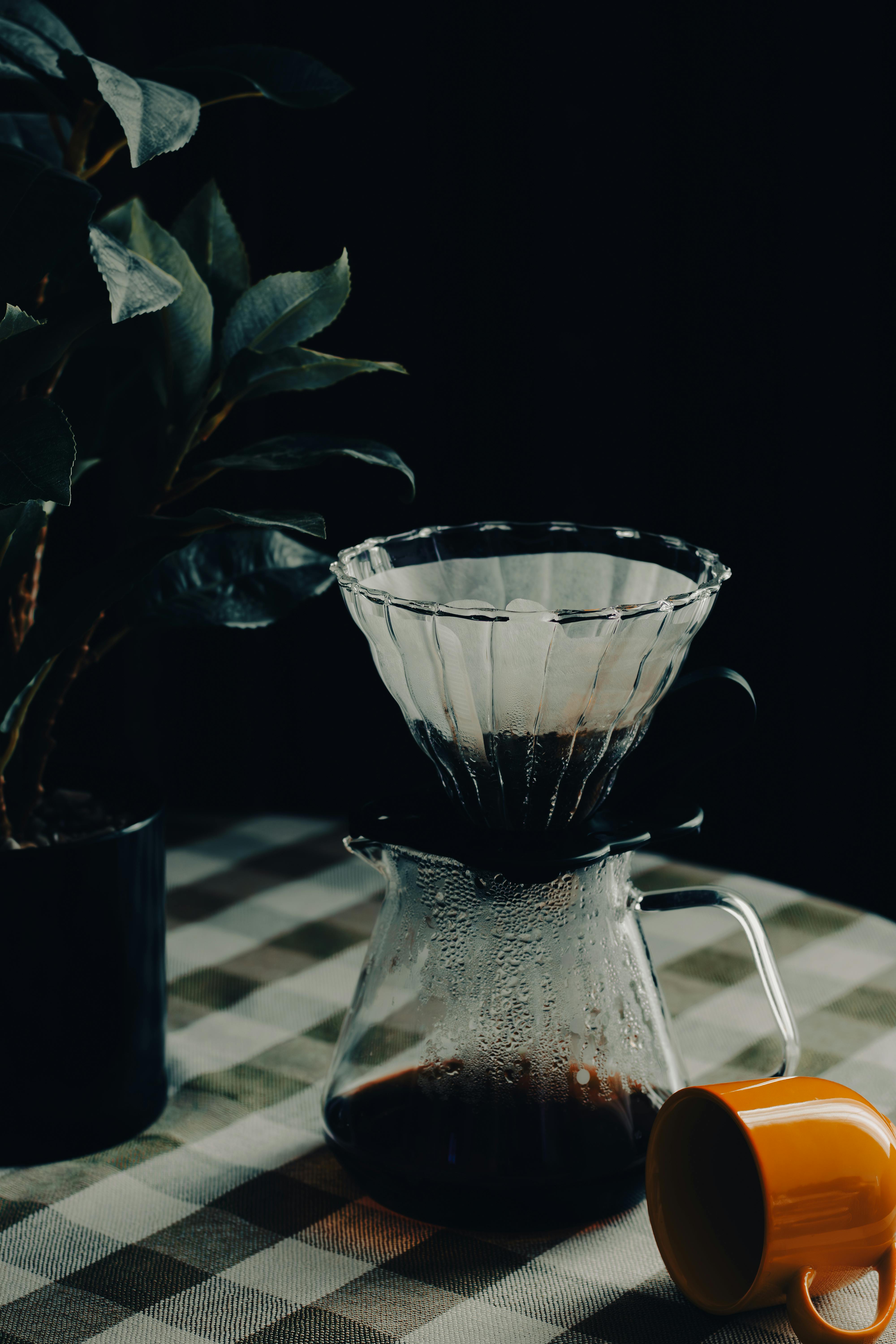 Free Elegantly brewed coffee with a glass filter on a checkered tablecloth indoors. Stock Photo