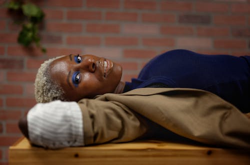 A woman laying on a table with her eyes closed