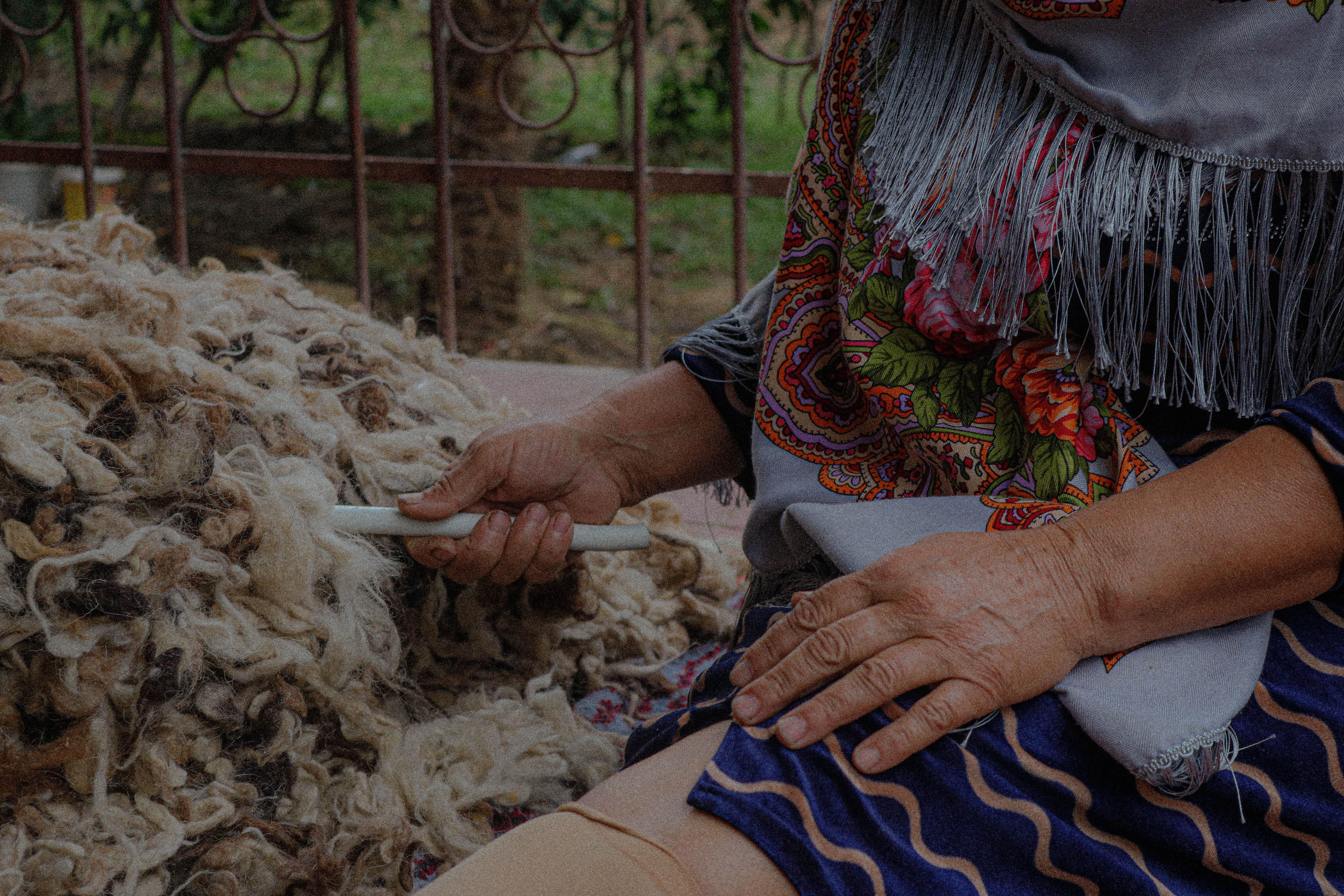 Person Talking Wool with a Stick · Free Stock Photo