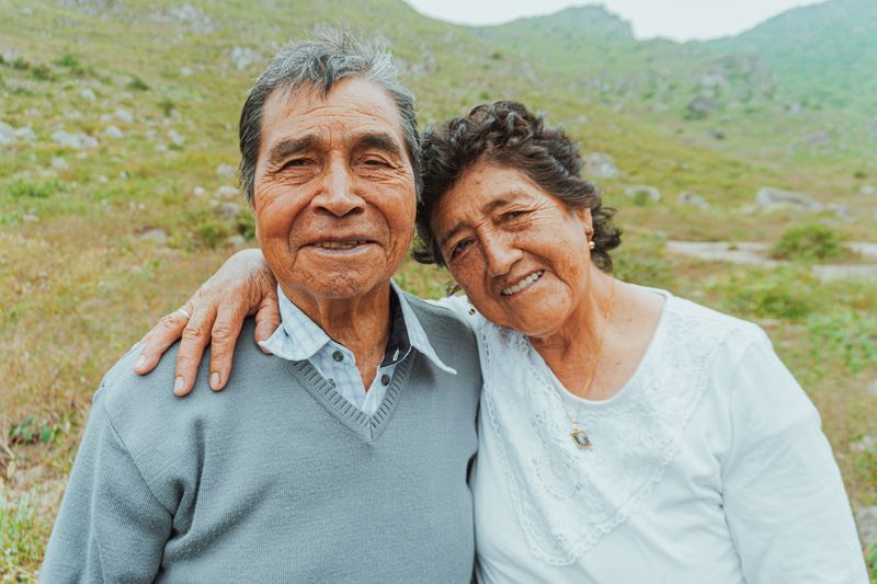 Elderly couple embracing outdoors