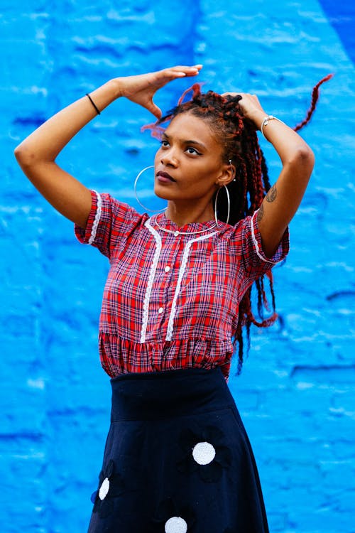 A woman with dreadlocks and a red shirt