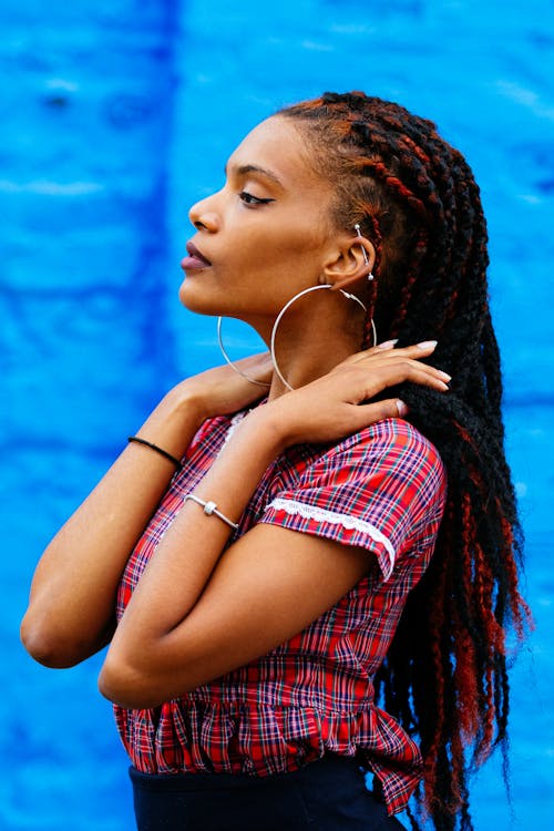 A woman with long dreadlocks and a red shirt