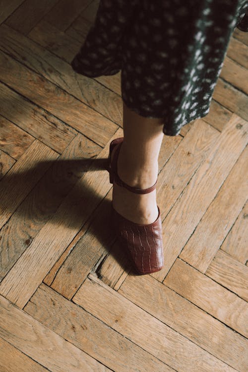 A woman's legs are shown in a pair of shoes