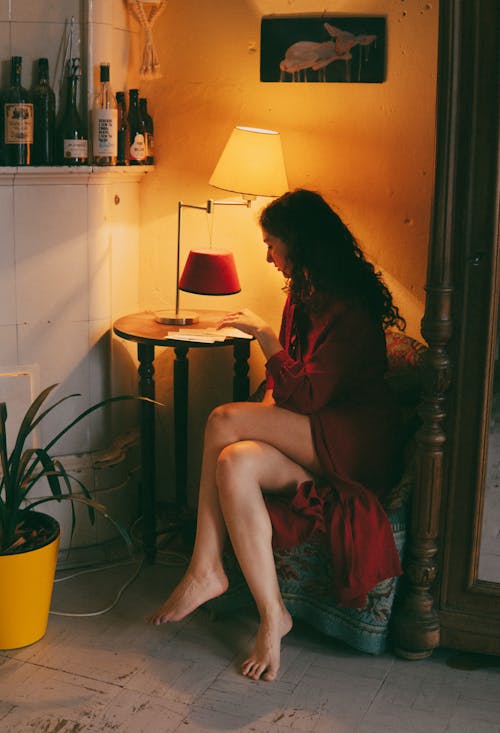 A woman sitting on a chair reading a book