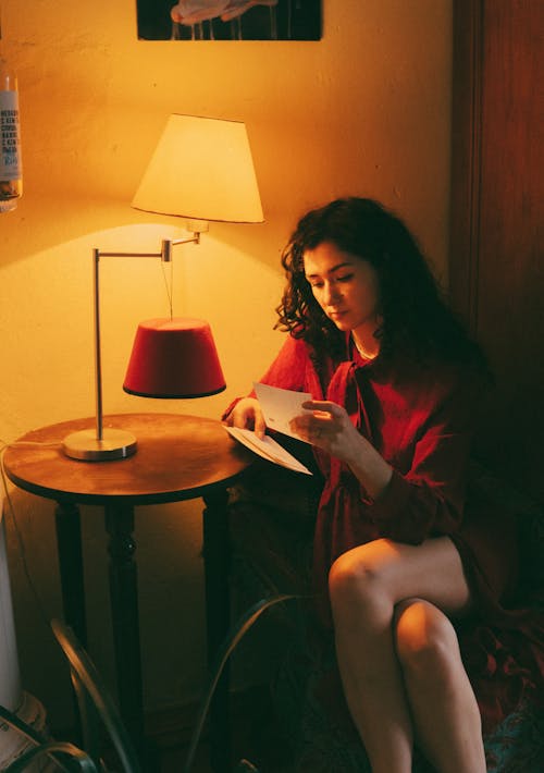 A woman sitting in a chair reading a book