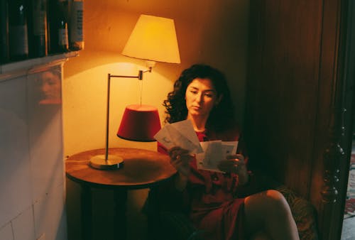 A woman reading a letter in a room