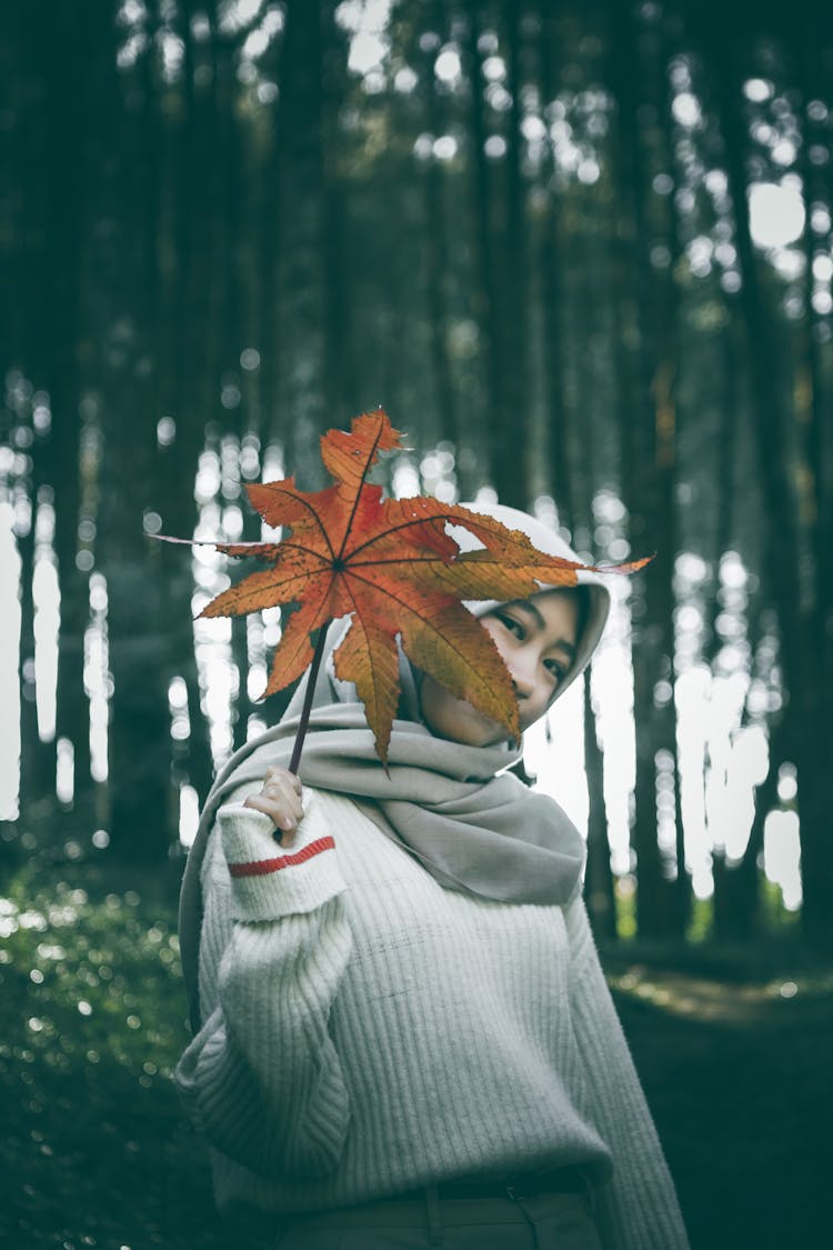 Woman Holding A Fall Leaf